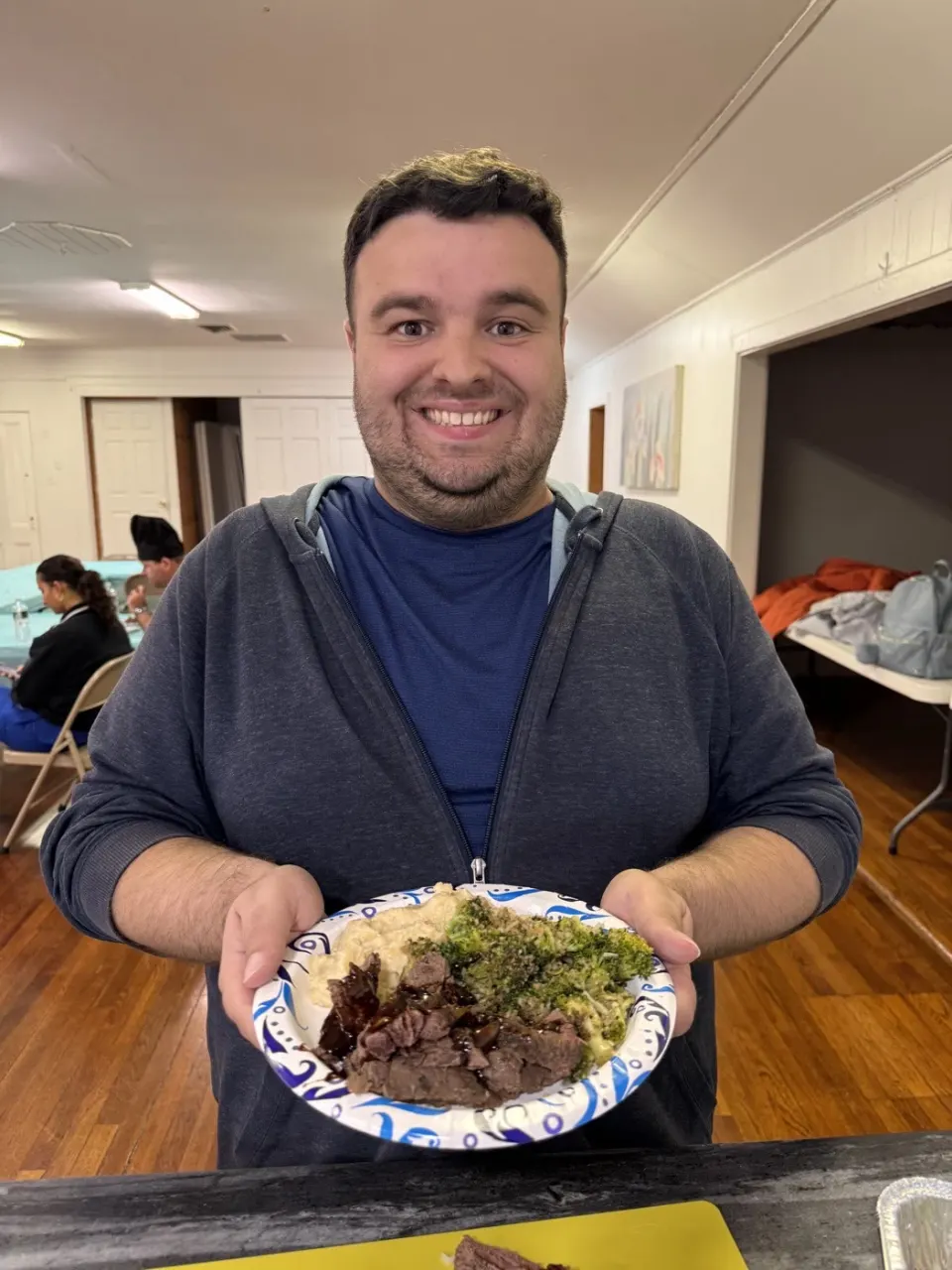 Move Academia cooking workshop member with their plated meal
